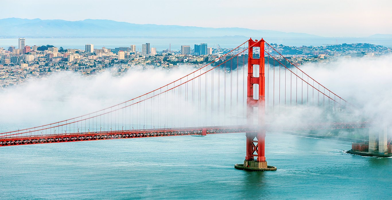 Golden Gate Bridge emerging from the fog over San Francisco Bay